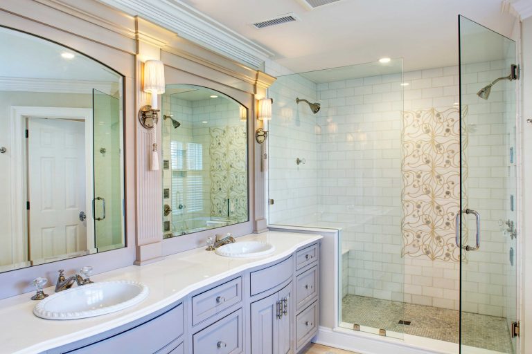 traditional style bathroom remodel white double sink vanity large separate shower stall with glass door and tile feature