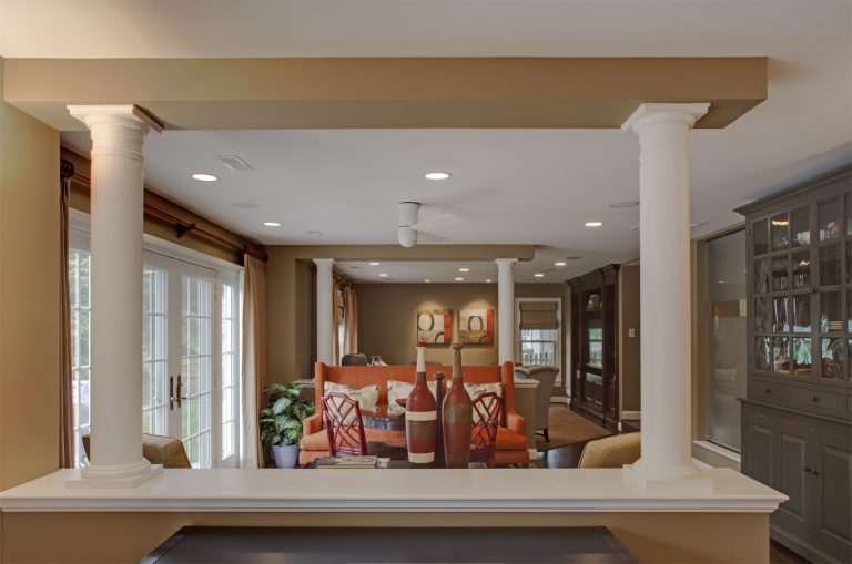 half wall and columns define separate living spaces warm color tones