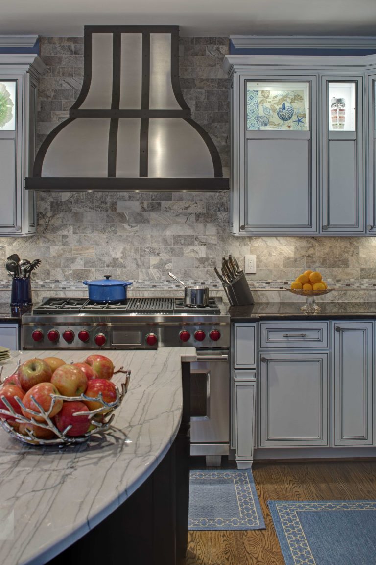 traditional style kitchen gray color palette center island stainless steel gas range with hood backsplash tile up to ceiling