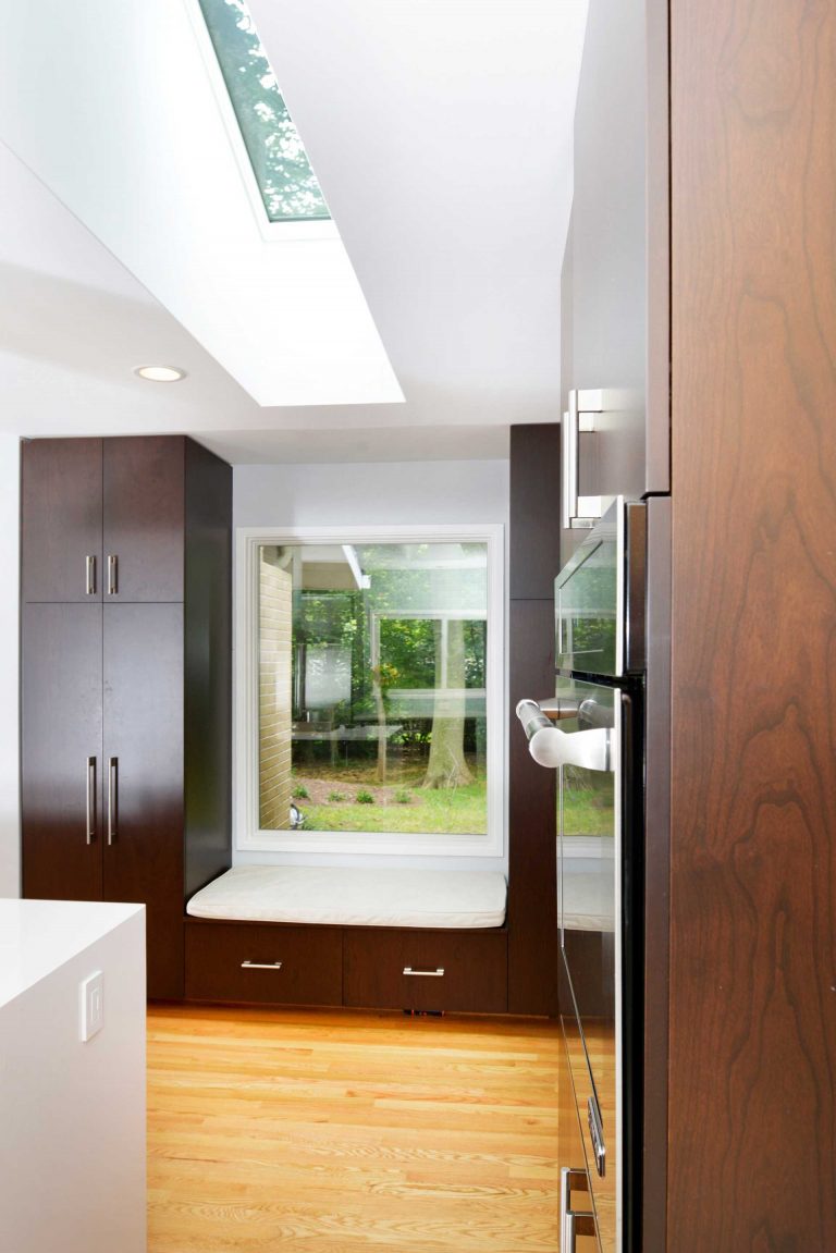 modern kitchen with skylights large windows and built in bench storage