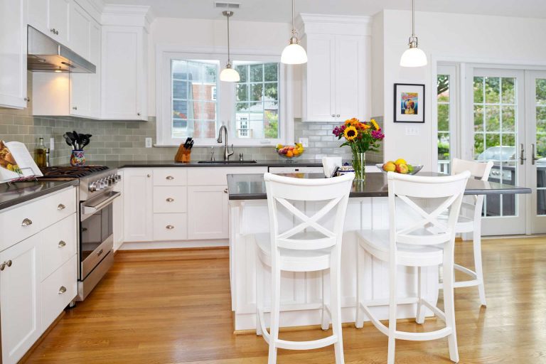 bright white kitchen wood floors pendant lighting over island french doors