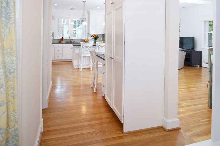 bright hallway leading to kitchen and living area built in storage