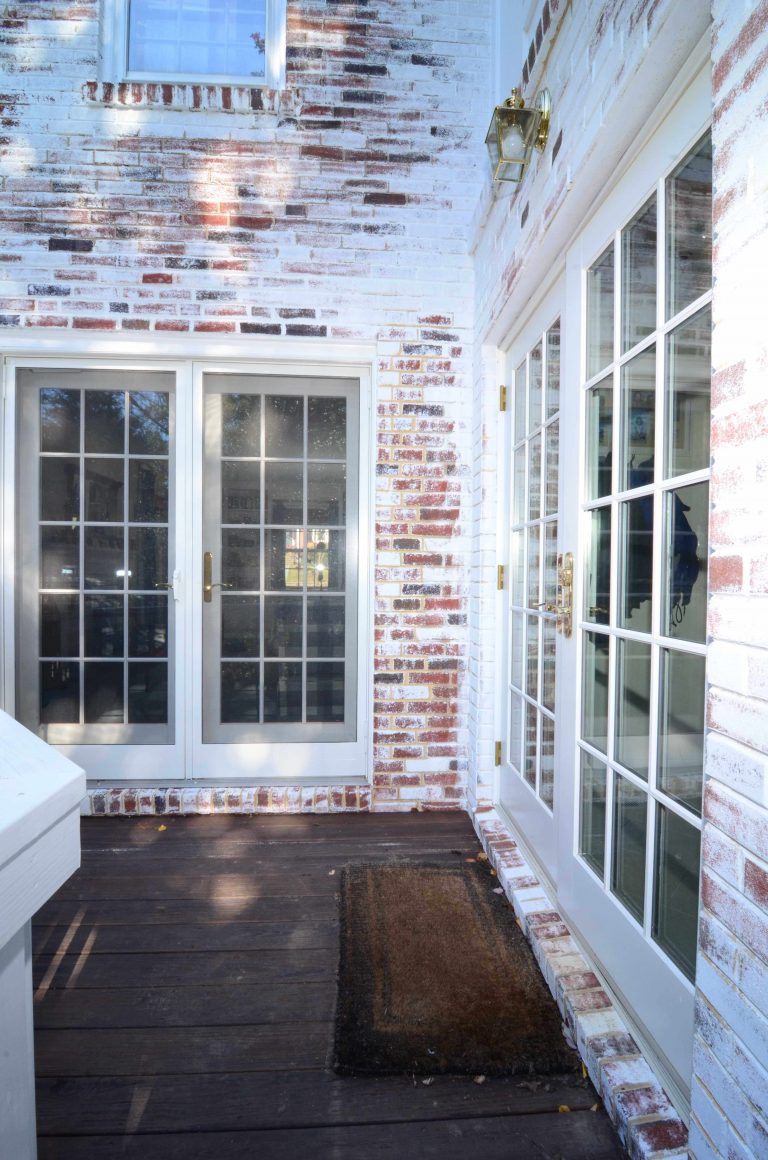 sliding glass doors lead to second level deck dark wood