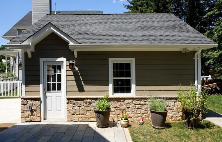 rear door and window of garage leading out to back patio beige neutral color palette