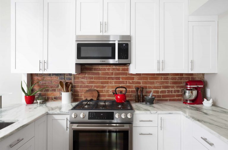 DC kitchen white cabinets red brick backsplash
