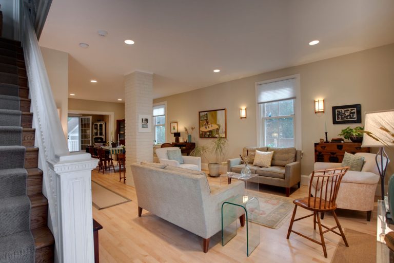 renovated living area in dc home light color palette exposed brick column