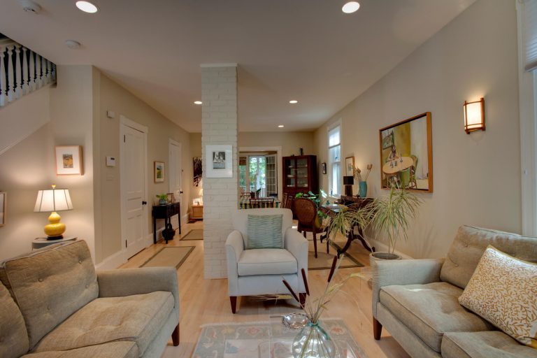 renovated living area in dc home light color palette exposed brick column