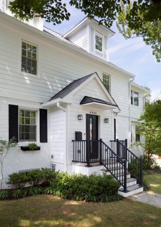 updated entryway on traditional white brick dc home iron railings