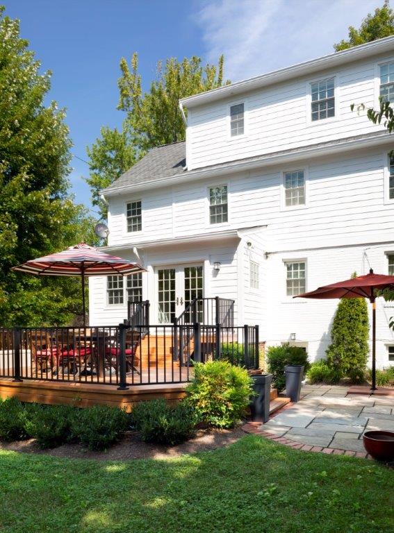 new outdoor living area glass doors lead to multi level stone patio