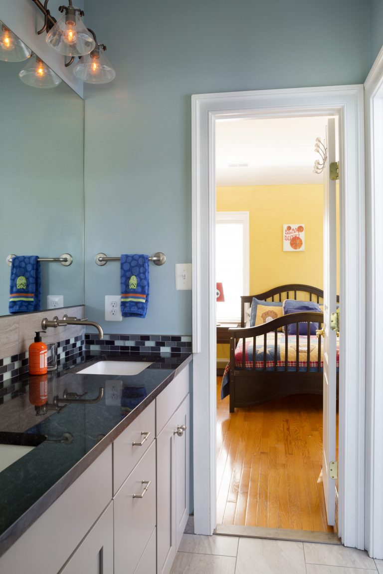 sleek updated bathroom with double sink vanity and blue color tones