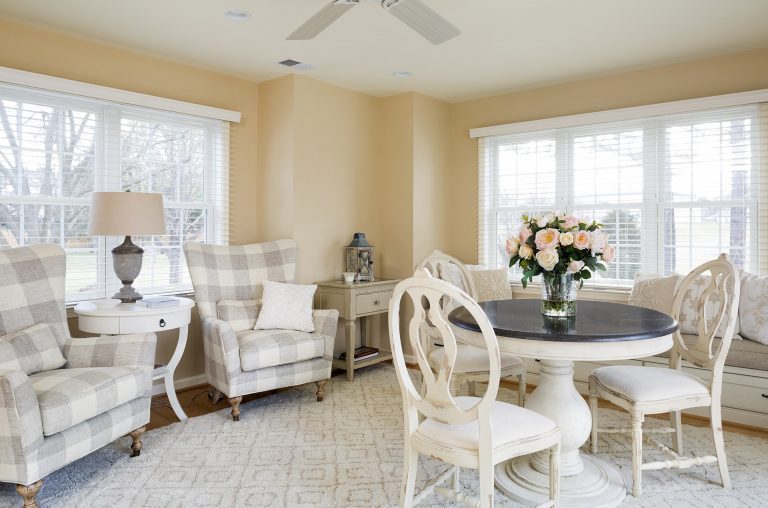 living area soft yellow color palette large windows built in window seat