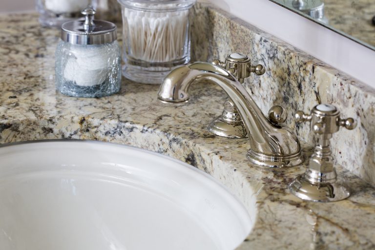 light beige granite countertop with polished nickel faucet