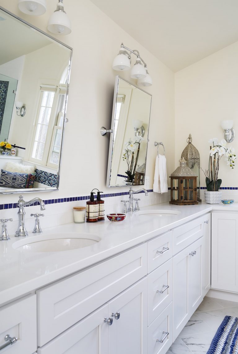 double sink vanity white cabinetry polished chrome fixtures sconce lighting