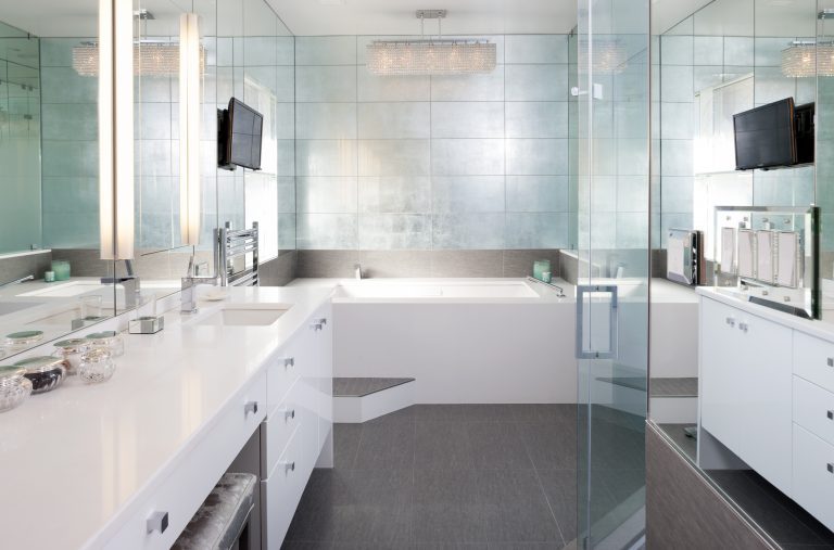 modern bathroom mirror wall vanity with white cabinets reflective tiles over bathtub