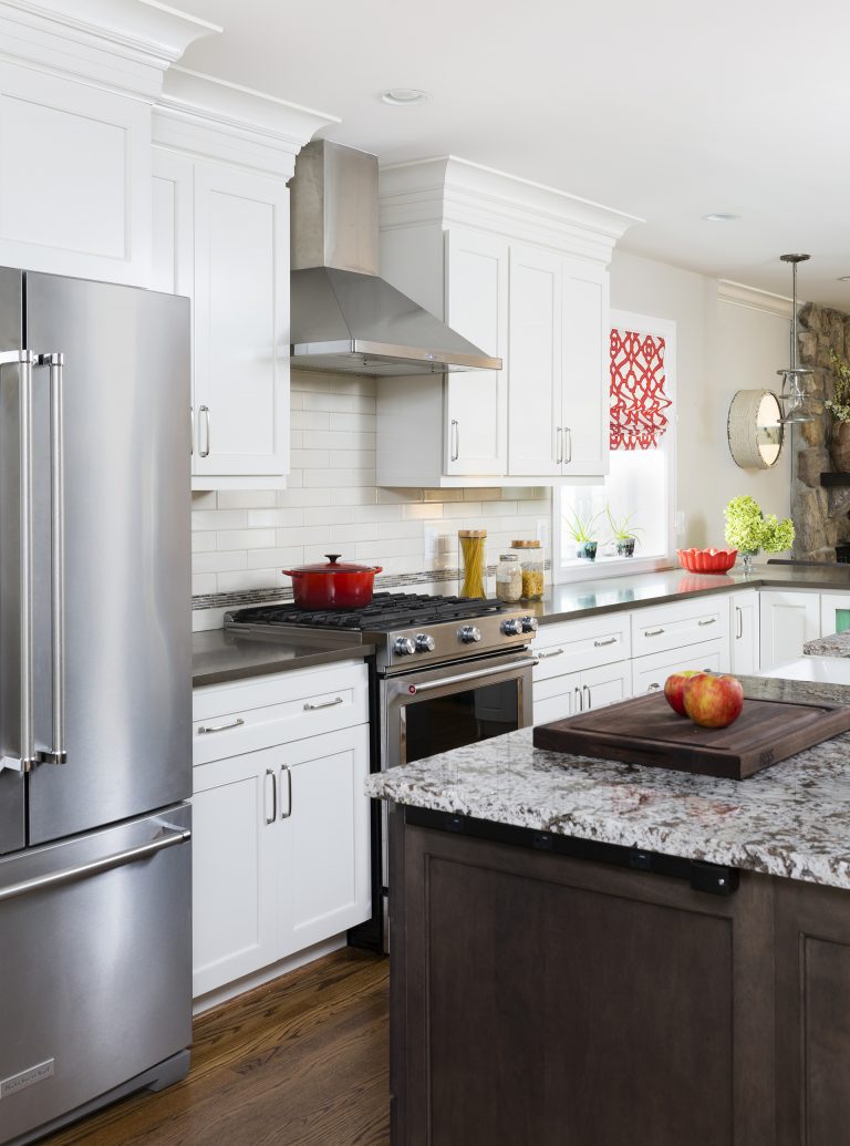 traditional kitchen white outer cabinetry dark wood island wood floors stainless steel appliances