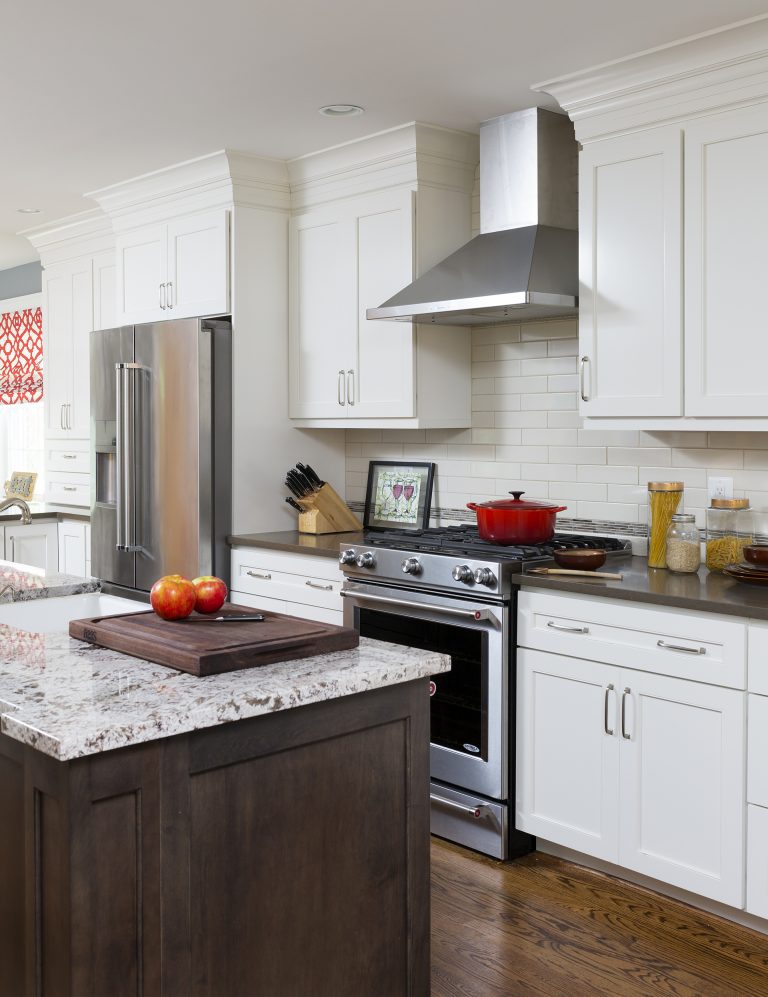 traditional kitchen white outer cabinetry dark wood island wood floors stainless steel appliances