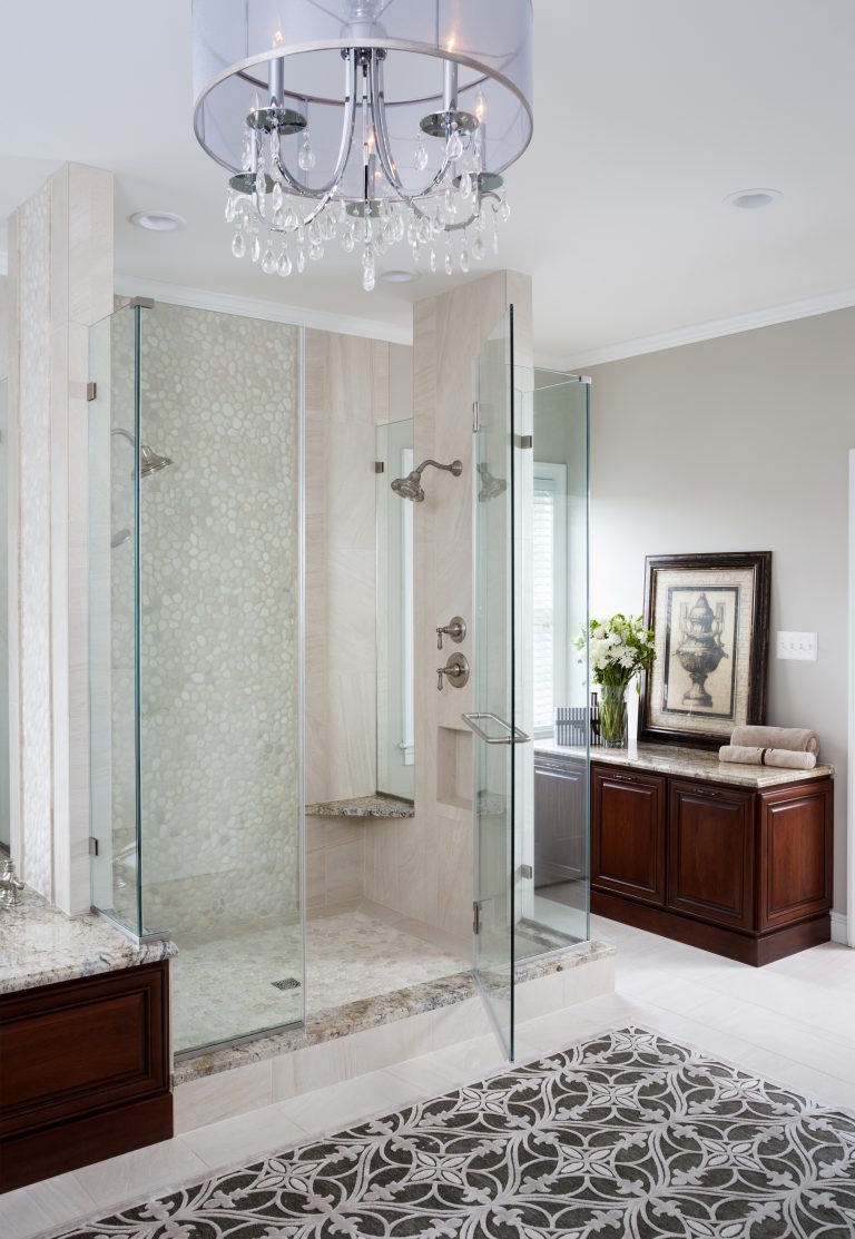 view of master bathroom shower chandelier and cabinet area