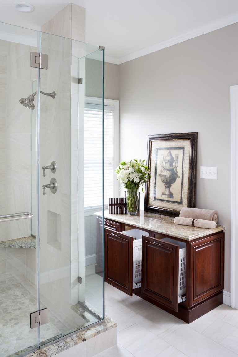 cabinetry to hide laundry hampers in master bathroom