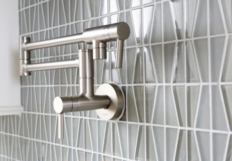 close up of kitchen backsplash and brushed chrome pot filler