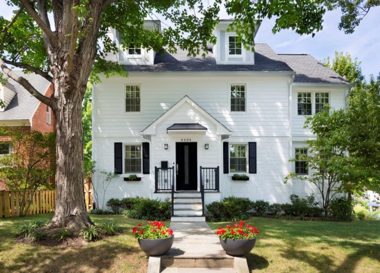 front view of white DC two story house with two dormers portico and walkway