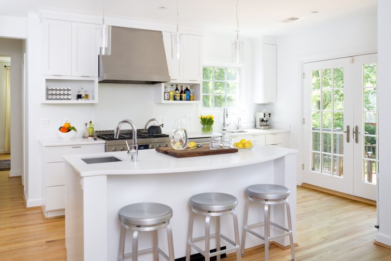 bright white kitchen with wood floors glass french doors island with seating stainless steel appliances