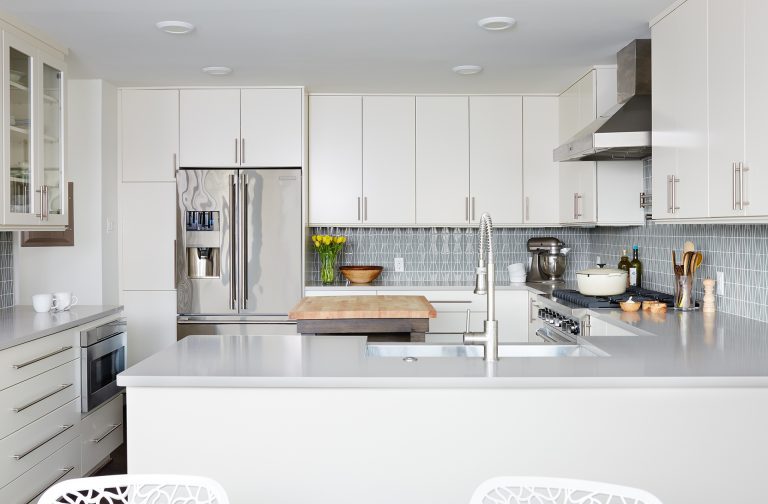 bright kitchen with stainless steel appliances and peninsula with seating