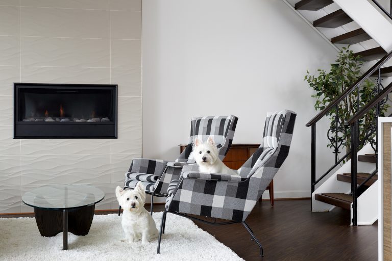 living room with textured fireplace surround and open staircase