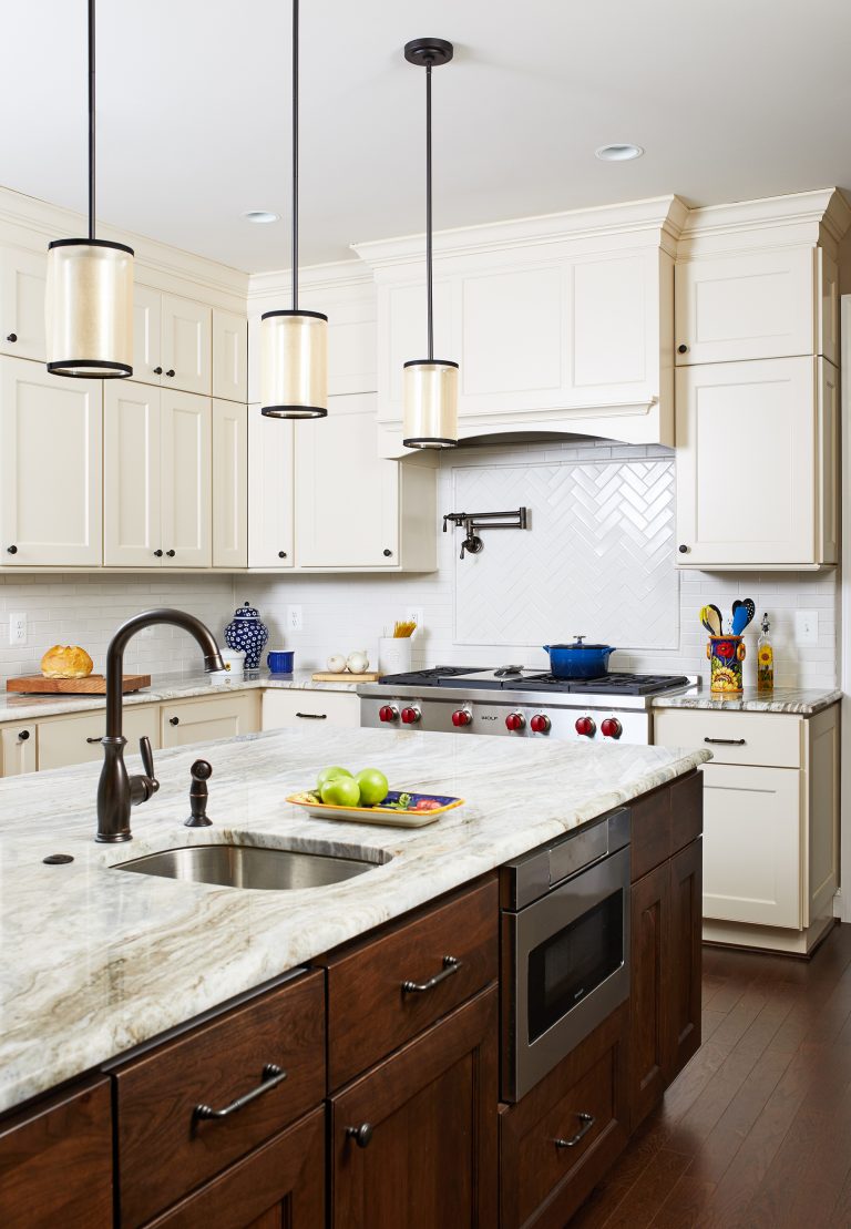 island with dark cabinetry and mini sink with bronze fixtures pendant lighting