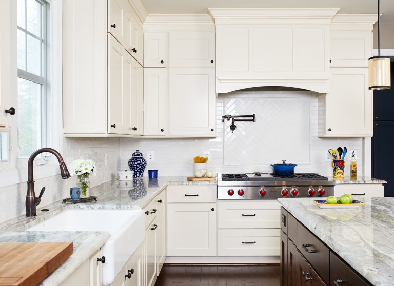 traditional style kitchen wood floors cream and dark brown cabinetry subway tile