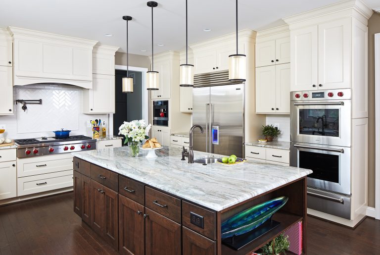 traditional kitchen with two tone cabinetry and stainless steel appliances separate gas range and wall oven