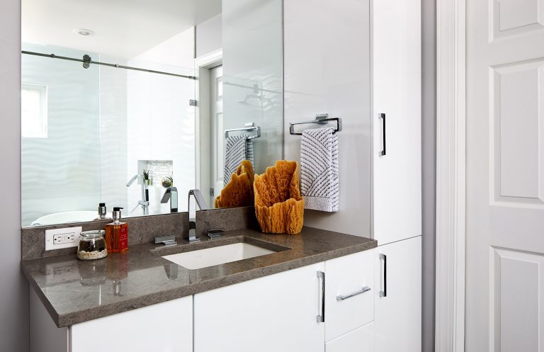 white cabinet vanity with sink and floor to ceiling storage