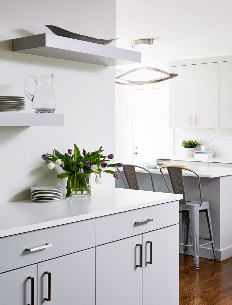 cabinetry with floating shelves above