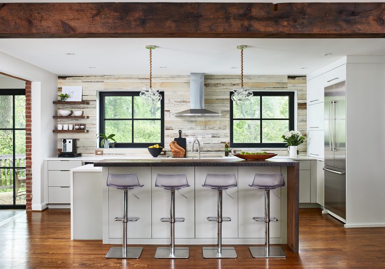 overview of kitchen wood beam entryway and exposed brick archway into living and dining rooms