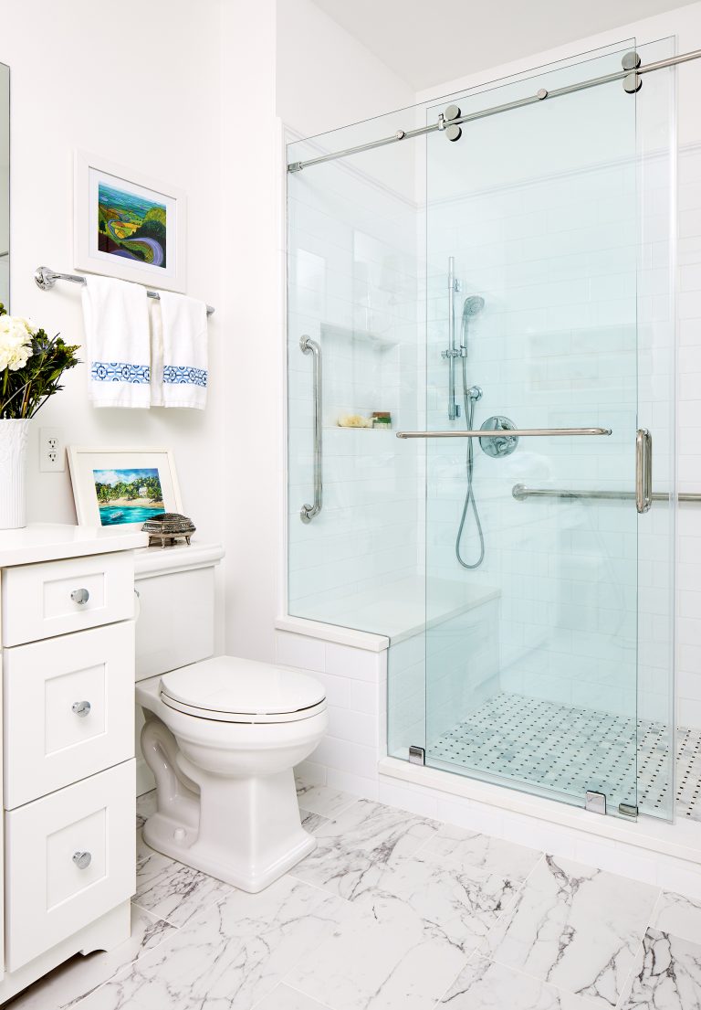 shower with inbuilt sit-down area and marble tile floors with ceramic subway tile on the walls