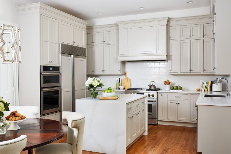 kitchen with built in fridge/freezer, double over, small kitchen island with subway backsplash and wood flooring