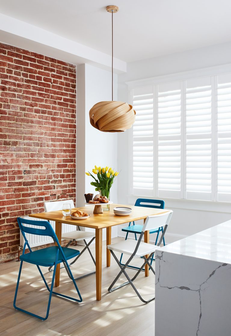 red brick wall with modern medium tone wood floor