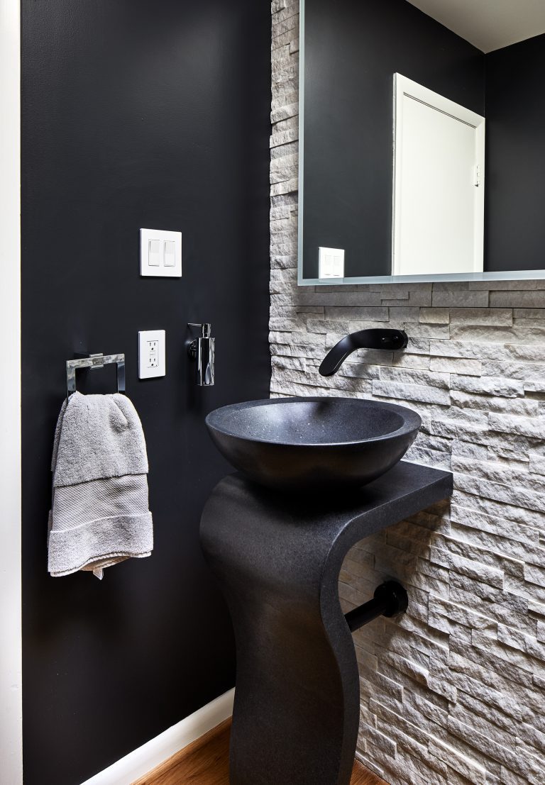exposed brick bathroom with black single washstand