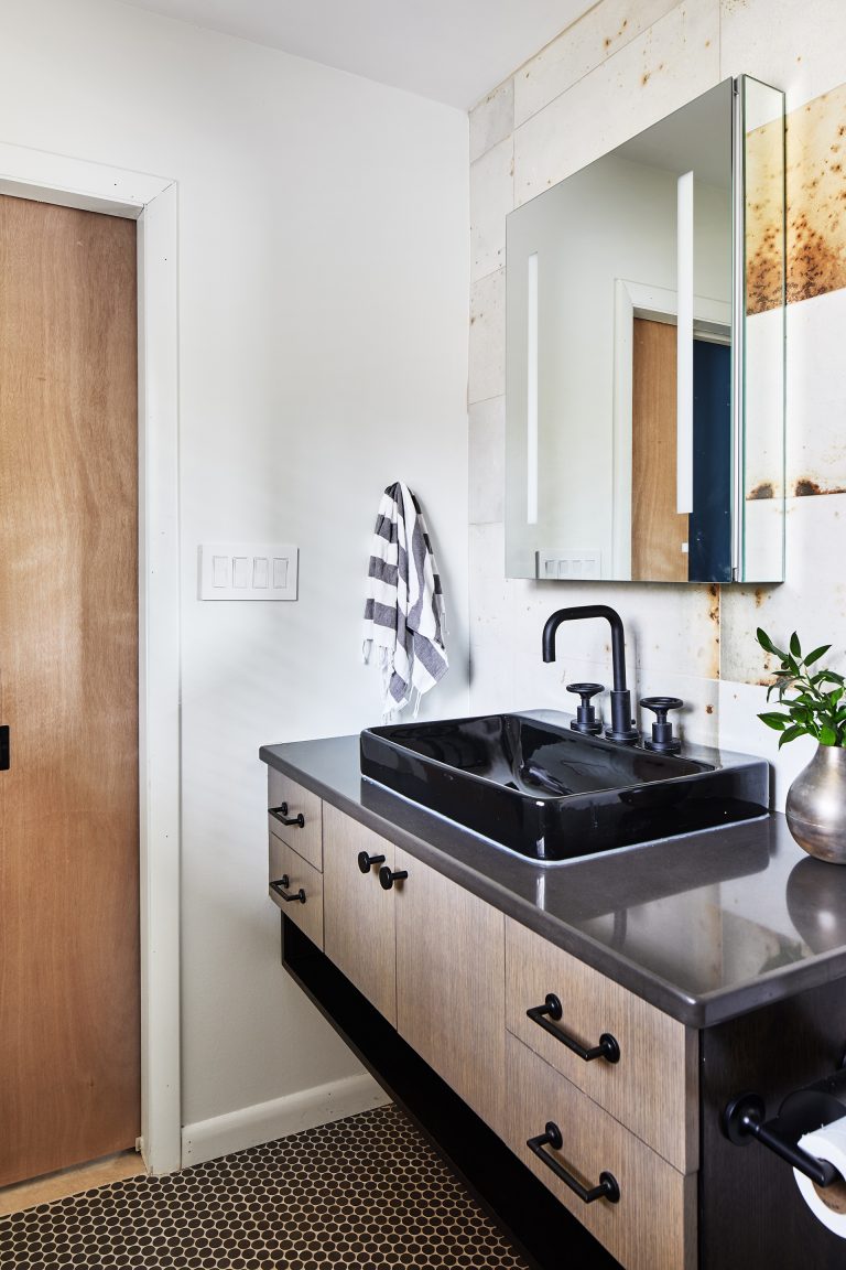 bathroom vanity with black basin sink in industrial style bathroom