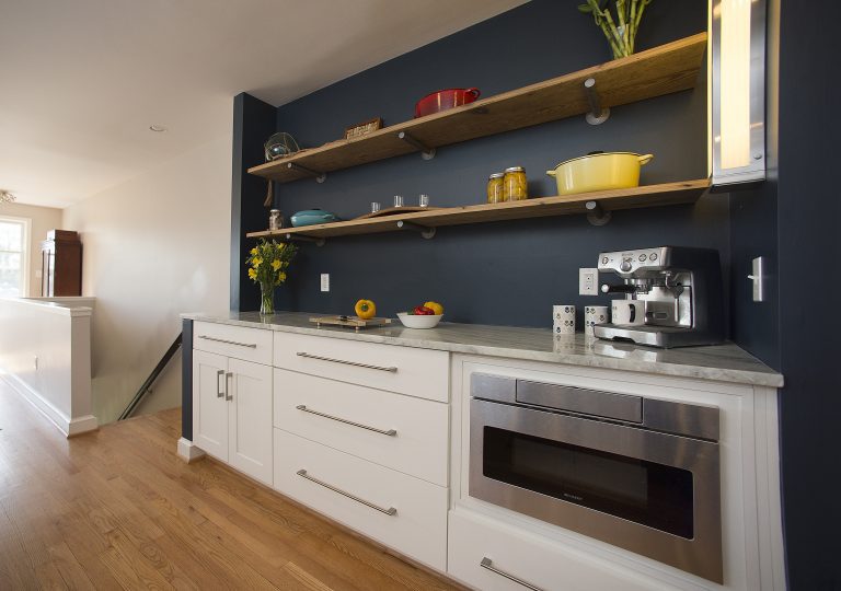 kitchen with navy walls white cabinetry open shelving stainless steel appliances