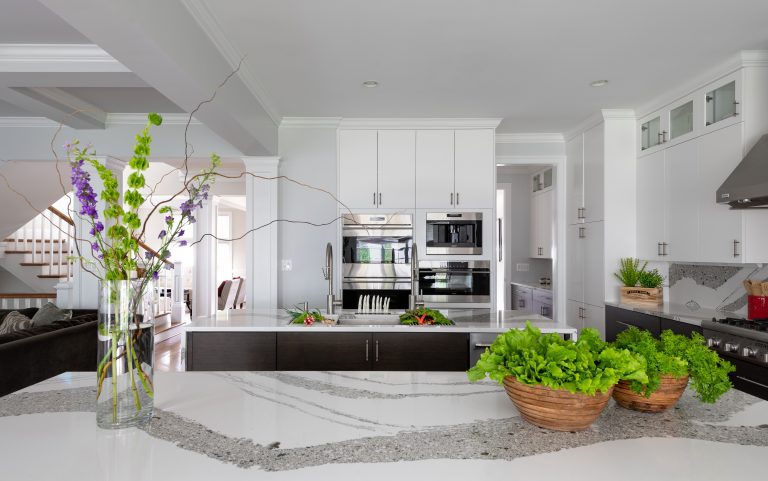 white cabinets with pull handles and kitchen island with sink