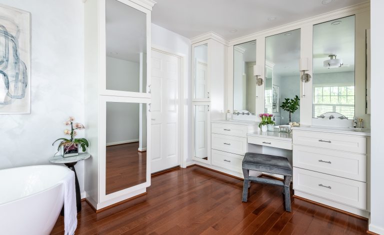 transitional Maryland bathroom with 3 arched mirrors over two sinks, with sconces in between