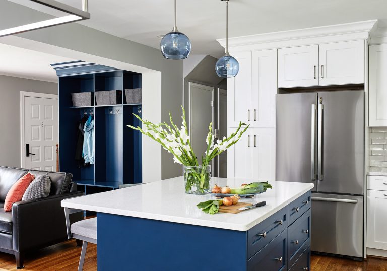 kitchen and living room opening with dark blue closet without doors matching kitchen island