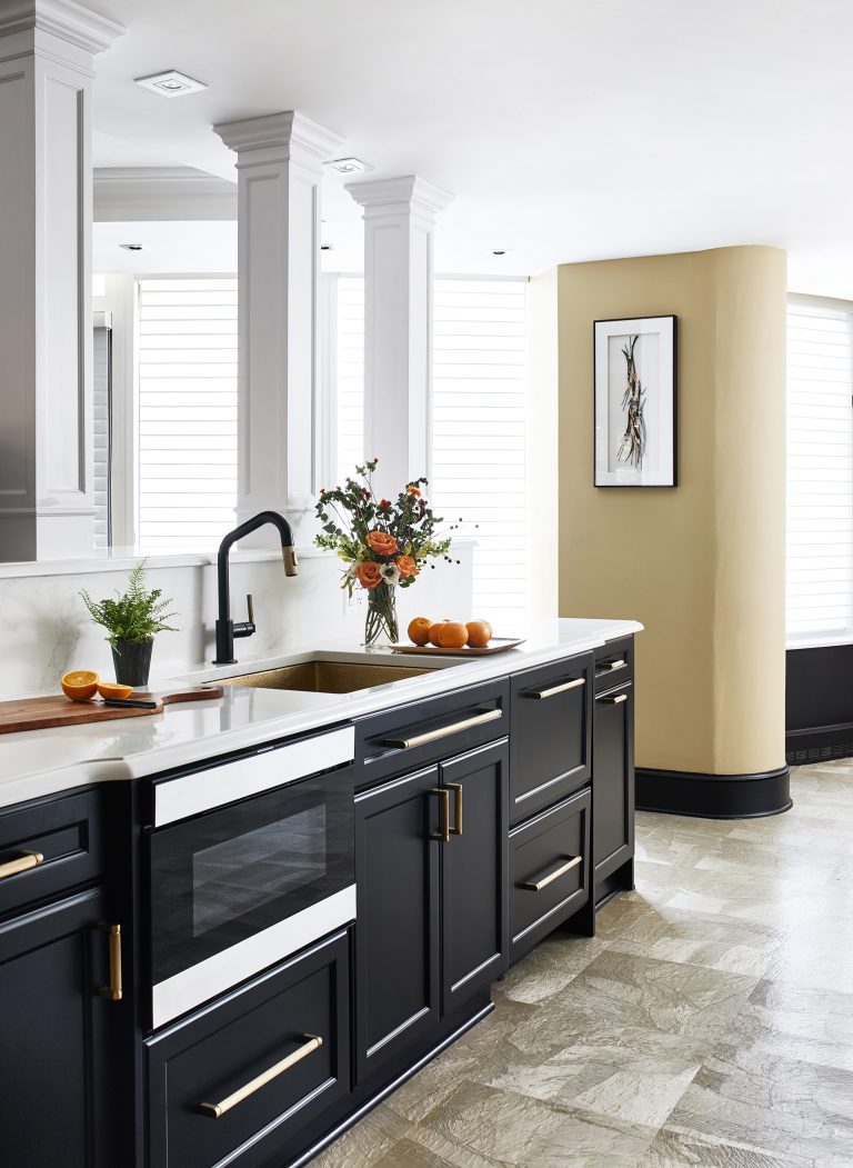 gold kitchen farmhouse sink and black mount pull down faucet with black and gold hidden behind cabinet panels